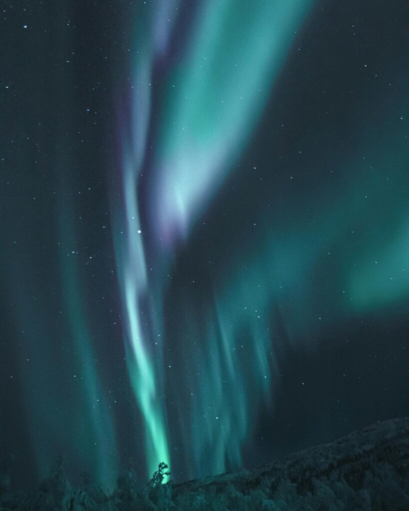 Captivating view of aurora borealis lighting up a starry night sky with vibrant colors and patterns.